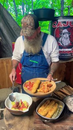 a man with a long beard is preparing food on a picnic table in the woods