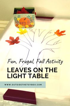 the leaves on the light table are cut out to look like fall leaves and have been made into a family tree