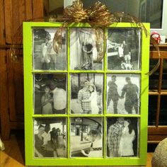 a green frame with pictures and a bow on the top is sitting in front of a wooden cabinet