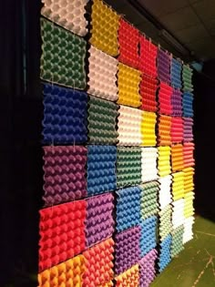 an art installation made out of plastic cups and other items on display in a dark room