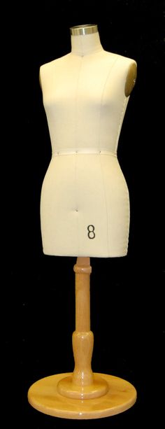 a white mannequin on a wooden stand with numbers 8 and eight in it