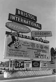 an old black and white photo of street signs