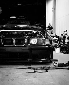 a black and white photo of a car in a garage