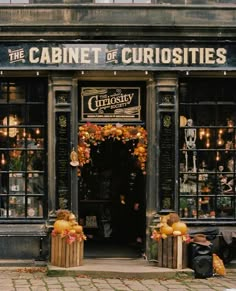 an entrance to the cabinet of curiosities with pumpkins on display in front