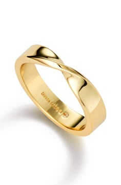 a yellow gold wedding ring with an elegant twist design on the outside, and a thin band