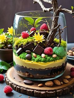 a glass bowl filled with green and yellow cake next to other desserts on top of a table