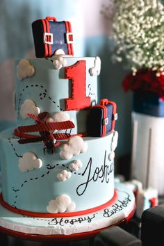 a three tiered cake decorated with red, white and blue decorations