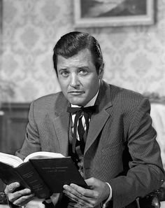 a man sitting at a table reading a book