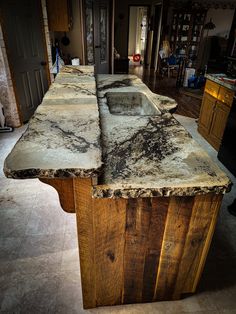 an old kitchen counter is covered in black and white marble, which has been stripped off