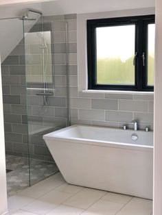 a white bath tub sitting next to a window