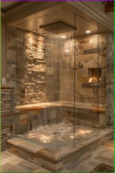 a walk in shower sitting next to a wall with stone walls and tile flooring