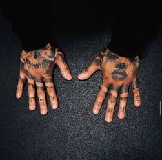 two hands with tattoos on them are shown