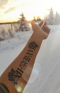 a person with a tattoo on their arm in the snow