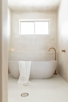 a white bath tub sitting next to a window