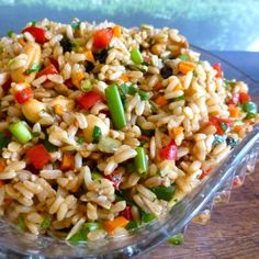 a glass bowl filled with rice and vegetables