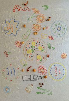 an embroidered table cloth with various designs and beads on it's surface, including flowers