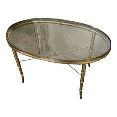 an oval glass table with metal legs