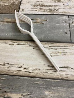 a white toothbrush sitting on top of a wooden floor