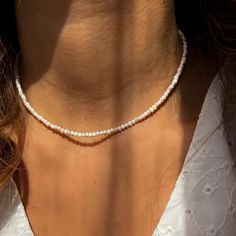 This delicate necklace is crafted with 2mm natural freshwater pearls for a minimalist and elegant look. Perfect for everyday wear or special occasions, the pearls radiate timeless beauty.  The necklace is designed with durable stainless steel findings and chain, ensuring it's resistant to tarnishing and suitable for long-term use. The adjustable chain allows for a customized fit, making it an ideal gift for anyone who loves dainty and sophisticated jewelry. Whether you're looking for a stylish p Small Pearl Necklace, Tiny Pearl Necklace, Sophisticated Jewelry, Necklace Everyday, Necklace Minimalist, Seed Pearl, Pearl Choker, Minimalist Necklace, Delicate Necklace