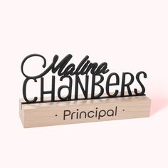 a black metal sign that says,'principals'on top of a wooden block