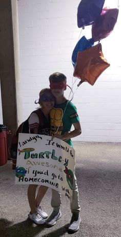 a man and woman are holding kites in the air while standing next to each other