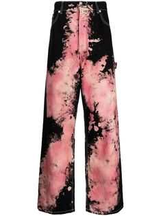 a pair of black and pink pants with tie dye on the bottom, in front of a white background