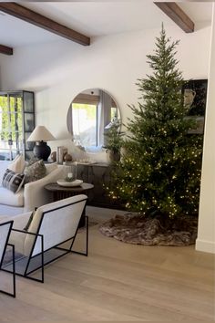 a living room filled with furniture and a christmas tree in the middle of the room