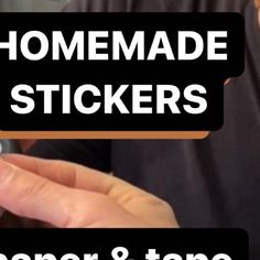 a person holding a cell phone with the text homemade stickers on it in front of them