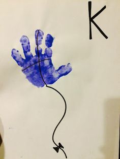 a child's handprint with the letter k on it, and an arrow