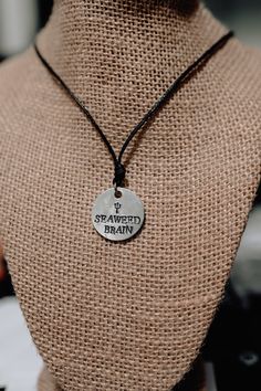 a close up of a mannequin wearing a necklace with a tag on it