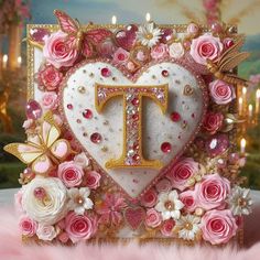 a heart shaped card with pink roses and gold trimmings in the shape of a letter t