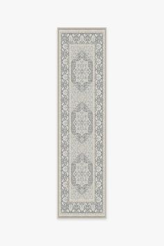 a white and gray rug with an intricate design