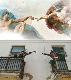 two men are painting the creation of adam and eve in front of a mural on a building