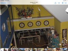 an aerial view of a dining room with yellow walls and blue trim around the table