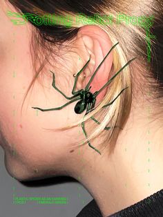 a woman's ear with a spider attached to the back of her ear,