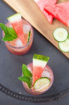 two glasses filled with watermelon, cucumber and mint garnish