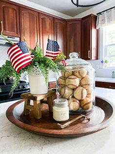 a wooden tray topped with baseballs on top of a kitchen counter