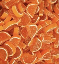 closeup of orange candies with sugar coatings on them, as if they were candy