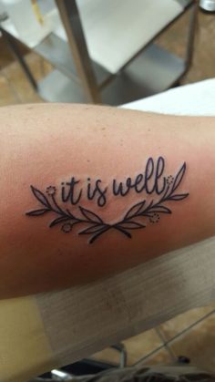 a tattoo with the word it is well written in cursive font on someone's arm