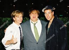 three men posing for the camera at an event