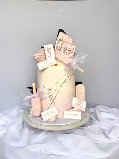 a white cake with pink and black decorations on it's side, sitting on a table