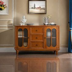 a wooden cabinet with glass doors on the front and bottom, in a living room