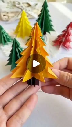 someone is making a christmas tree out of paper