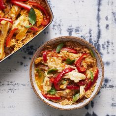 two bowls filled with food on top of a table