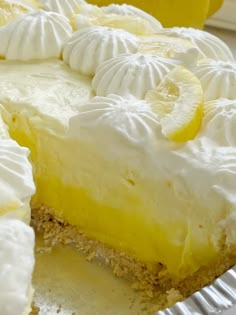 a close up of a pie with lemons and whipped cream on the top,