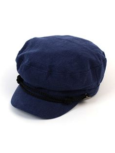 a blue hat is sitting on a white surface