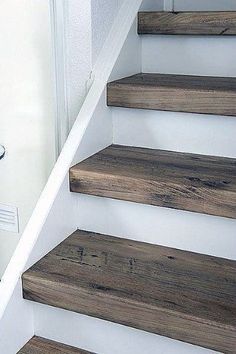 the stairs are made from wood and have been painted white with dark brown stain on them