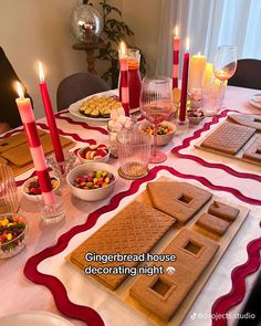 the table is set with cookies, candy and other treats for a holiday dinner or party