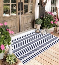 the front porch is decorated with potted plants