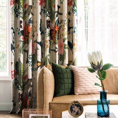 a living room filled with furniture and curtains